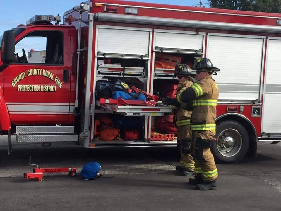 firefighters gather equipment from rural rescue truck