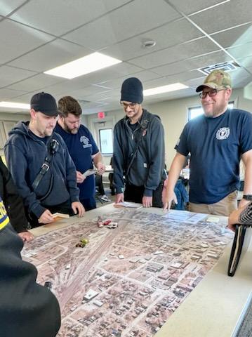 responders study map of scene